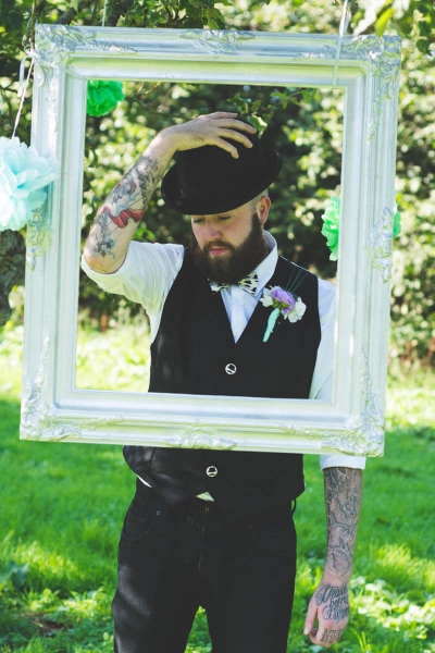 Groom with quirky waistcoat and bowler hat